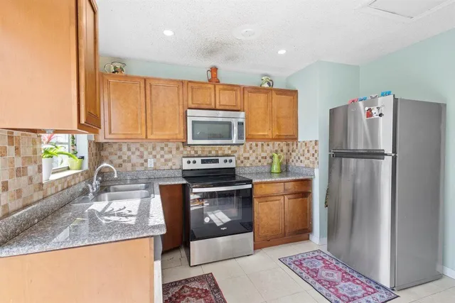 a kitchen with a refrigerator sink and microwave