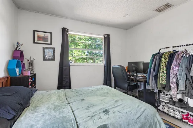 a bedroom with a bed and a desk