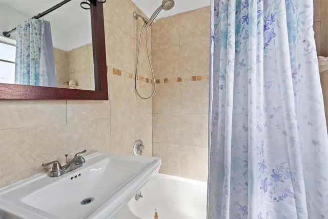 a bathroom with a sink a mirror and a shower