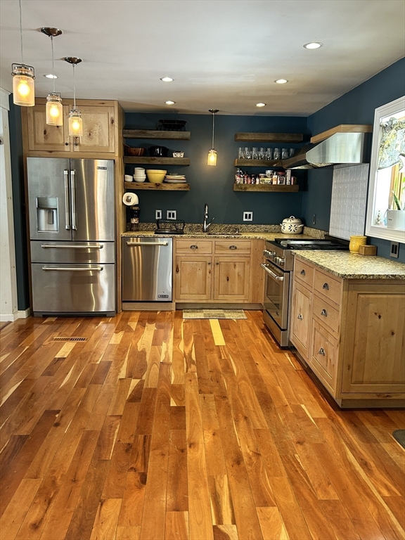 552 Dwight Road Springfield, MA 01108 - Photo 12 of 33 a large kitchen with stainless steel appliances kitchen island granite countertop a refrigerator and a stove top oven