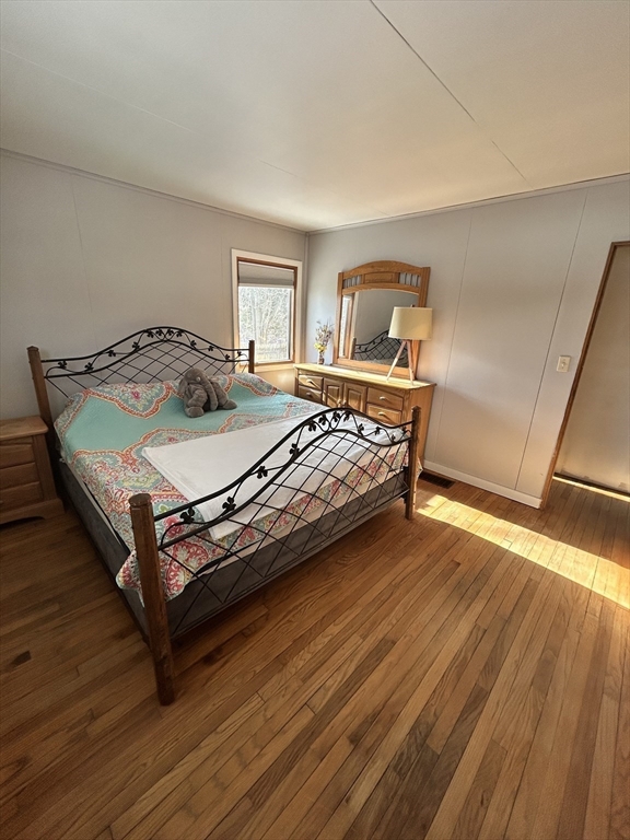 552 Dwight Road Springfield, MA 01108 - Photo 19 of 33 a bedroom with a bed and wooden floor