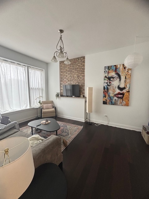 3477 North Clark Street, Unit 2 Chicago, IL 60657 - Photo 2 of 13 a living room with furniture and a fireplace