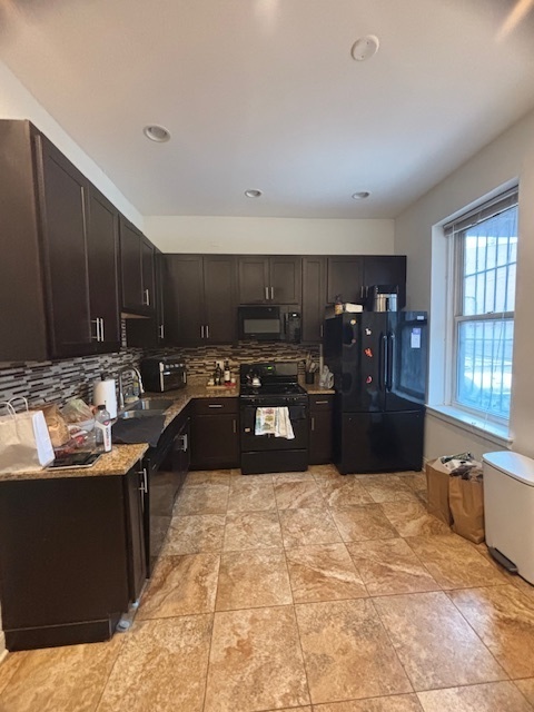 3477 North Clark Street, Unit 2 Chicago, IL 60657 - Photo 3 of 13 a kitchen with stainless steel appliances granite countertop a stove and a sink