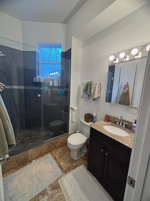 3477 North Clark Street, Unit 2 Chicago, IL 60657 - Photo 5 of 13 a bathroom with a sink a toilet a mirror and shower