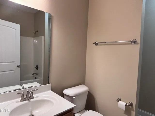 a bathroom with a sink toilet and a mirror