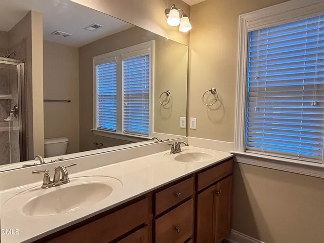 a bathroom with a sink double vanity and a mirror