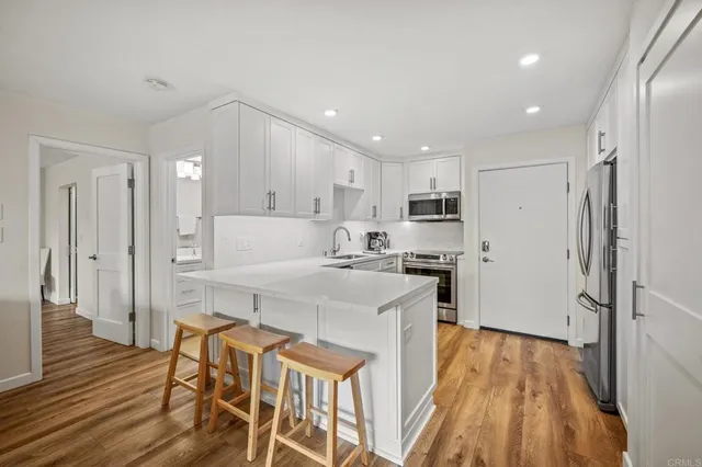 a large kitchen with a table and chairs