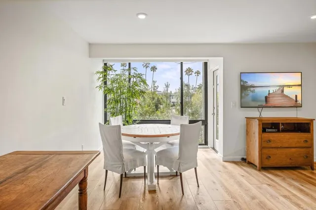a view of a dining room with furniture window and wooden floor