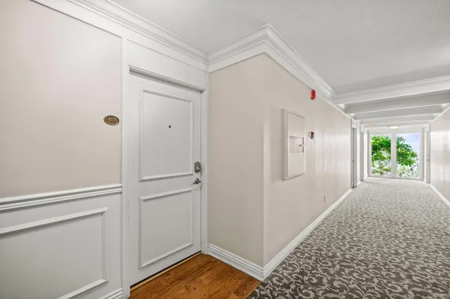 a view of empty room with window and wooden floor