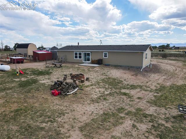 961 Buffalo Run Road Calhan, CO 80808 - Photo 14 of 45 Rear view of house with a patio area and a fire pit