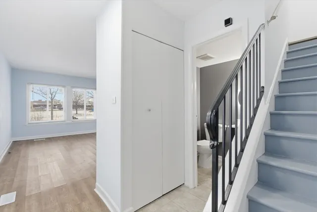 a view of a hallway with wooden floor and entryway