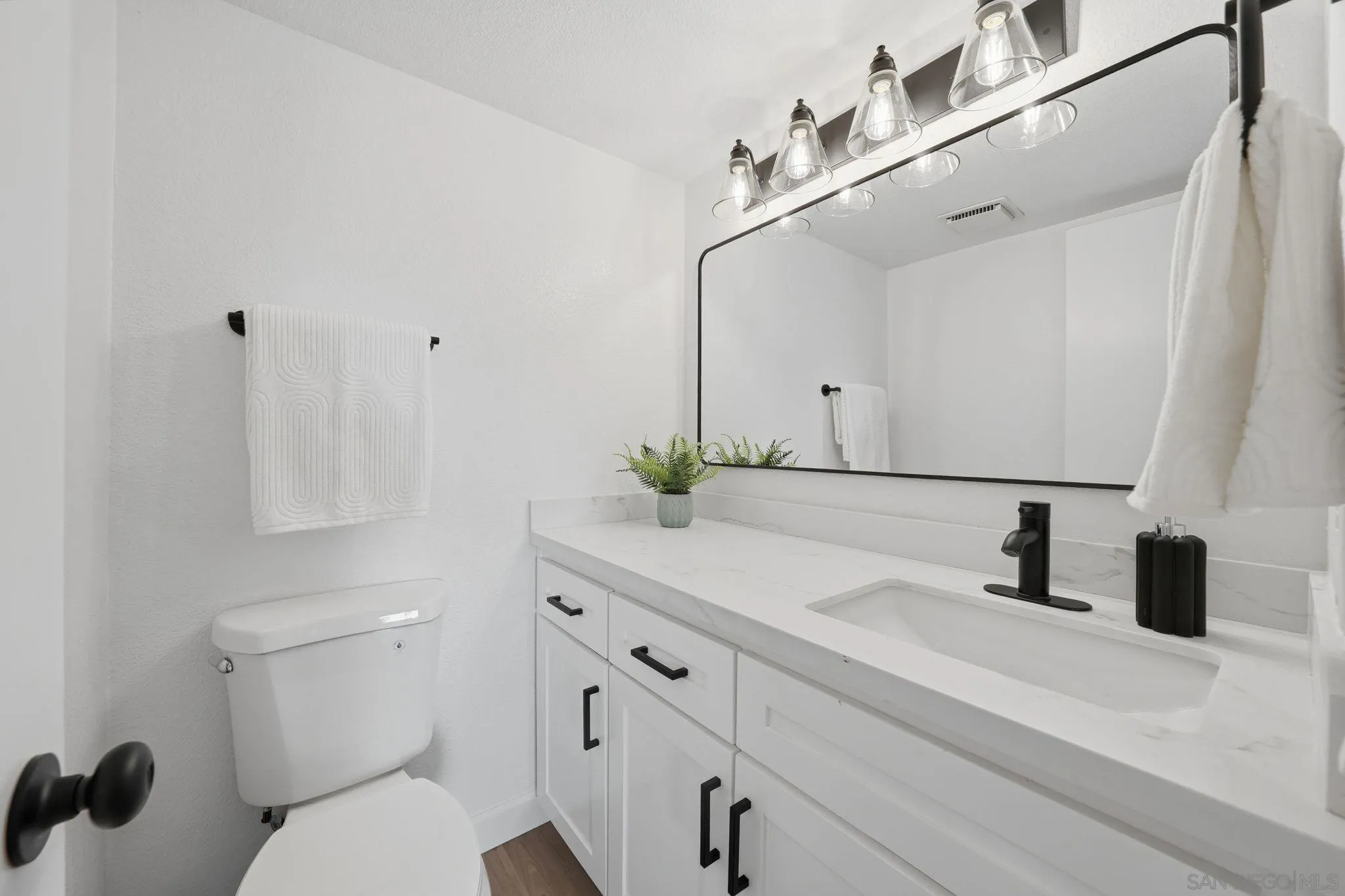 10450 Ridgewater Lane San Diego, CA 92131 - Photo 18 of 47 a bathroom with a sink a toilet and vanity