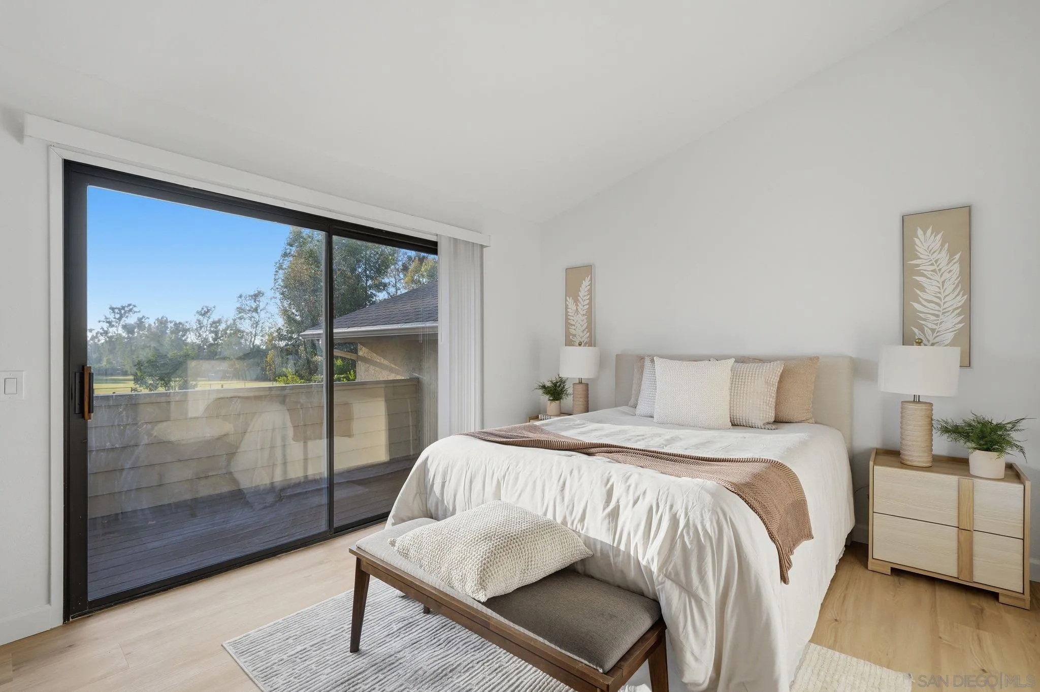 10450 Ridgewater Lane San Diego, CA 92131 - Photo 19 of 47 a bedroom with a bed and wooden floor