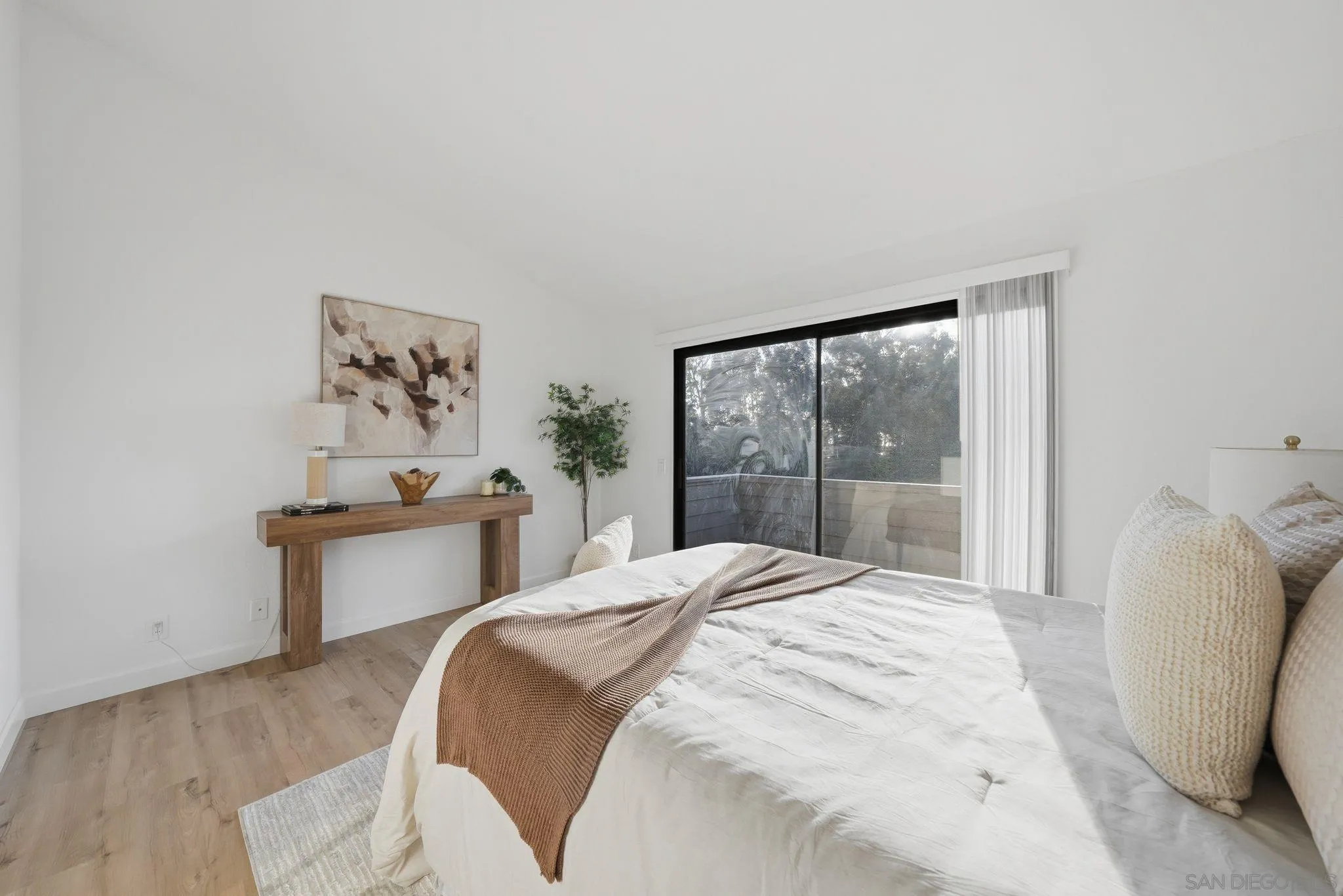 10450 Ridgewater Lane San Diego, CA 92131 - Photo 23 of 47 a bedroom with a bed and a large window