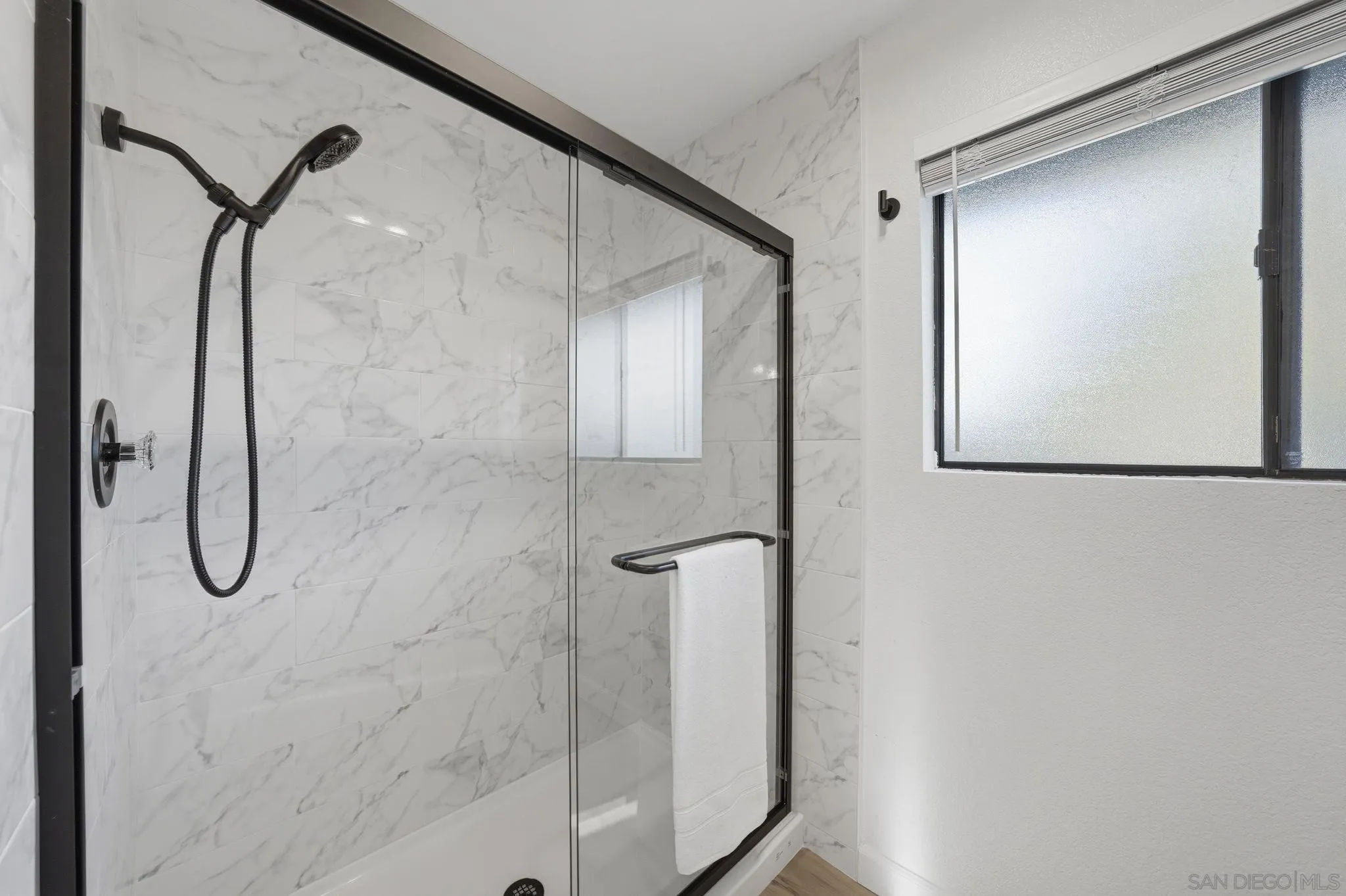 10450 Ridgewater Lane San Diego, CA 92131 - Photo 25 of 47 a bathroom with a shower and a mirror