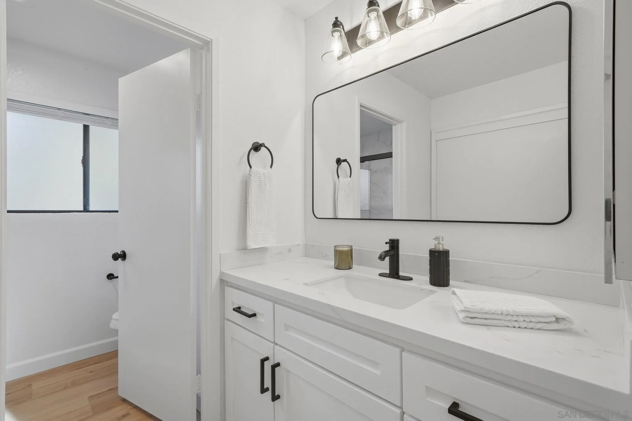 10450 Ridgewater Lane San Diego, CA 92131 - Photo 28 of 47 a bathroom with a sink and a mirror