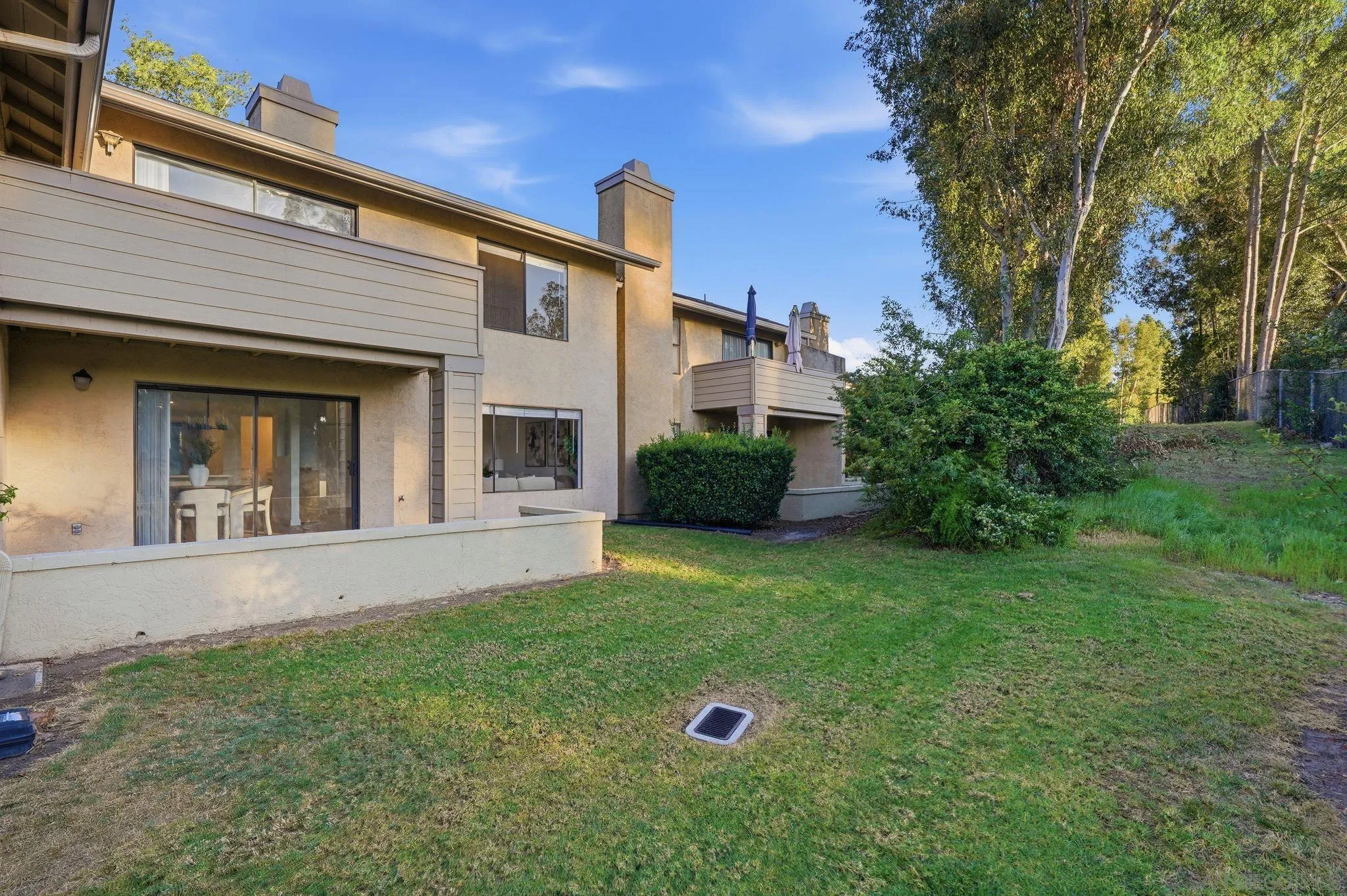 10450 Ridgewater Lane San Diego, CA 92131 - Photo 34 of 47 a view of a white house with a yard
