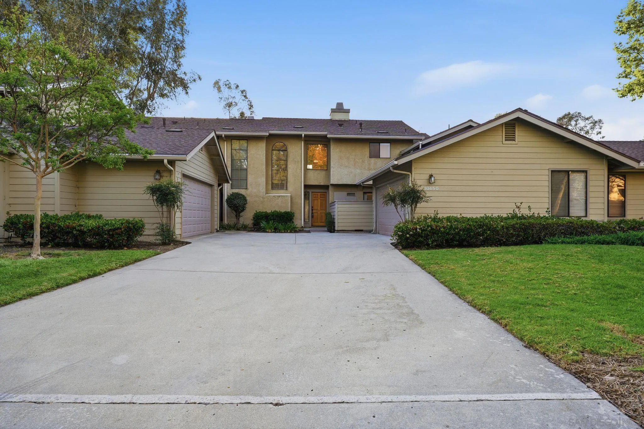 10450 Ridgewater Lane San Diego, CA 92131 - Photo 38 of 47 a front view of a house with a yard and garage