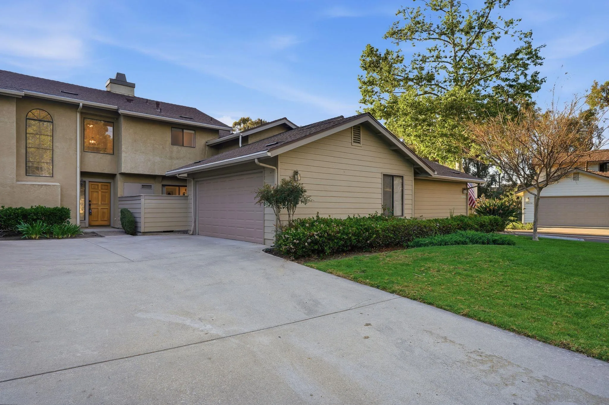 10450 Ridgewater Lane San Diego, CA 92131 - Photo 39 of 47 a front view of a house with a yard and garage