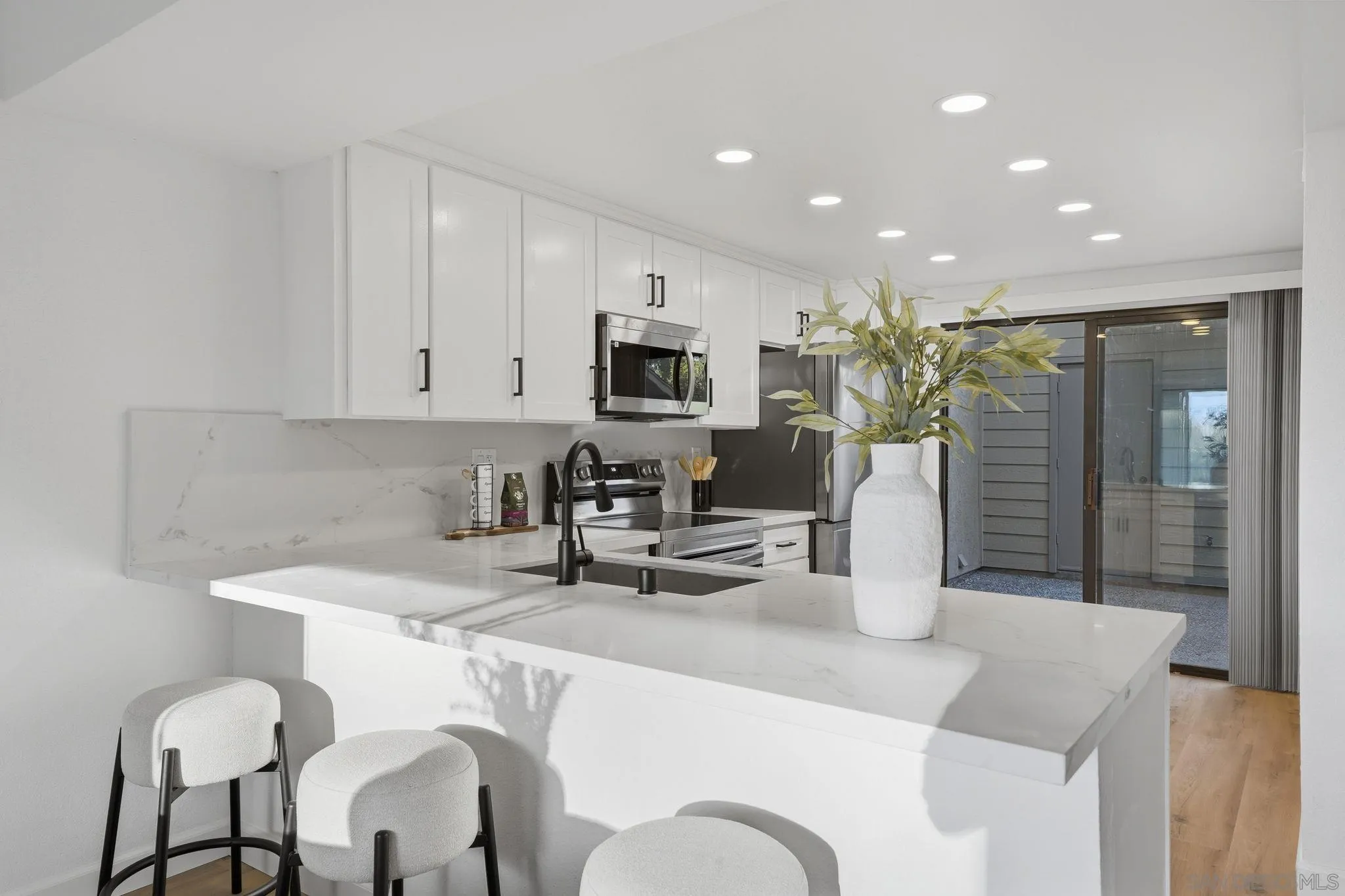 10450 Ridgewater Lane San Diego, CA 92131 - Photo 5 of 47 a kitchen with stainless steel appliances granite countertop a sink and a refrigerator