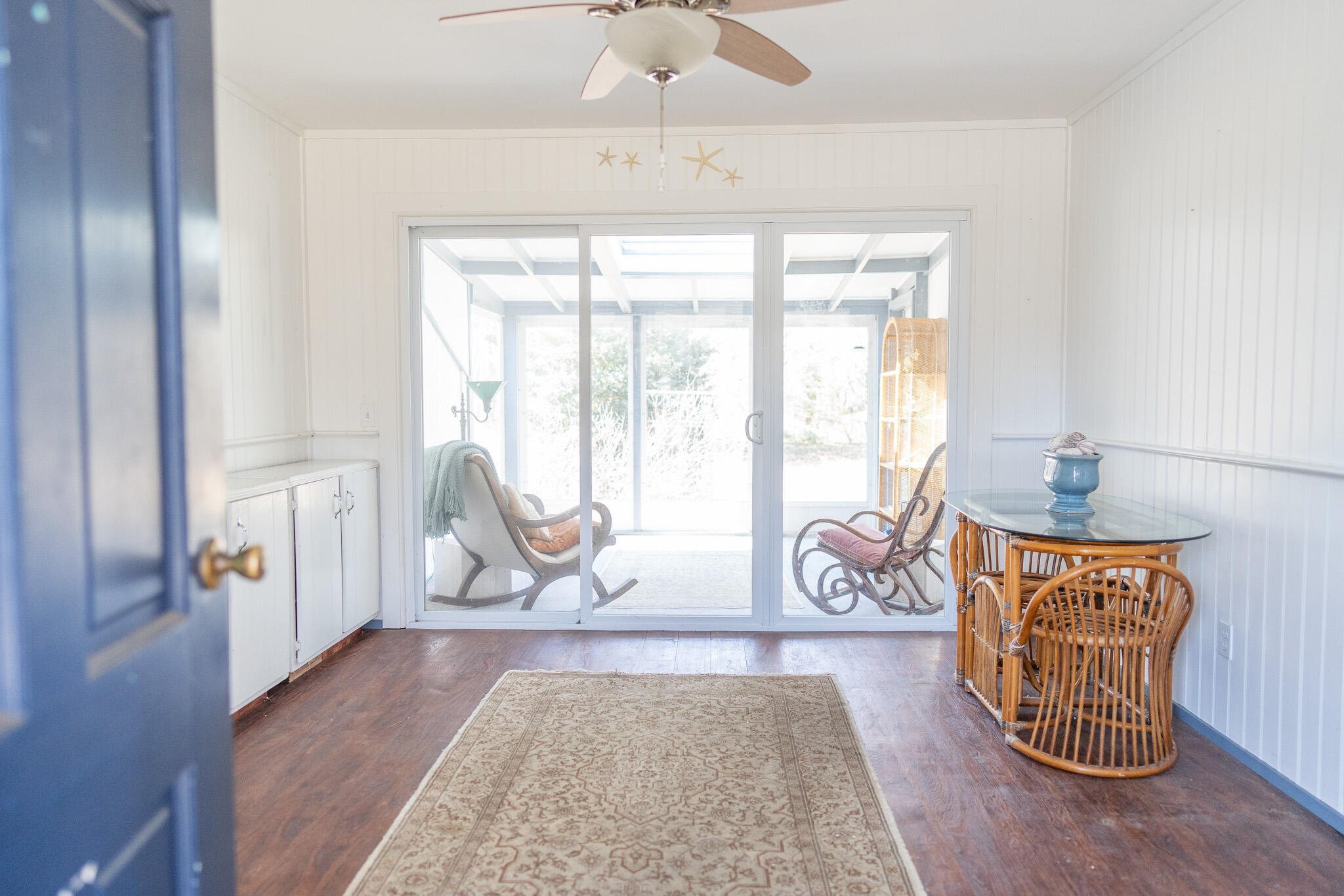 49 Monument View Road East Dennis, MA 02660 - Photo 16 of 52 a living room with furniture a table and a large window