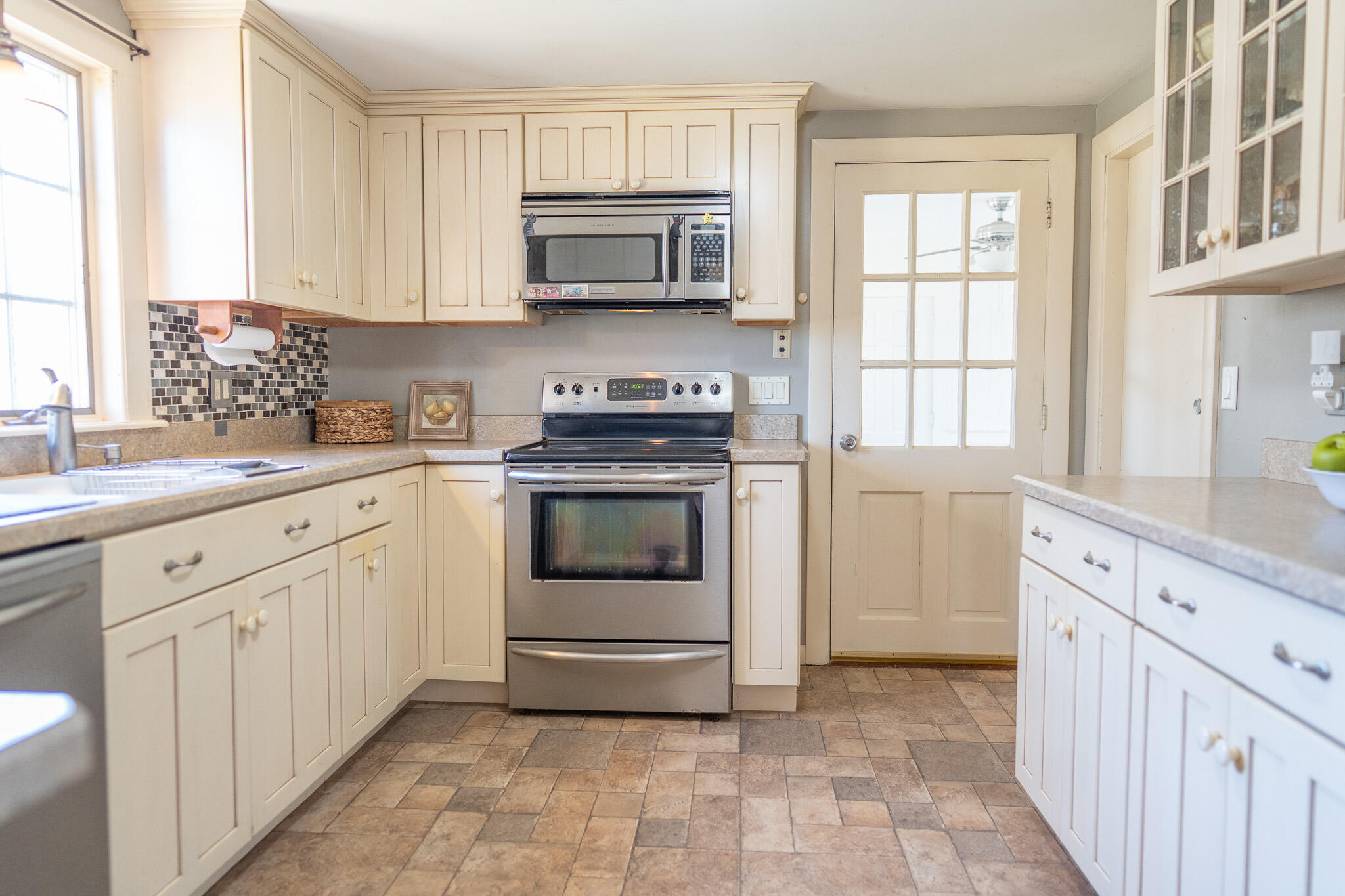 49 Monument View Road East Dennis, MA 02660 - Photo 20 of 52 a kitchen with granite countertop white cabinets and white appliances