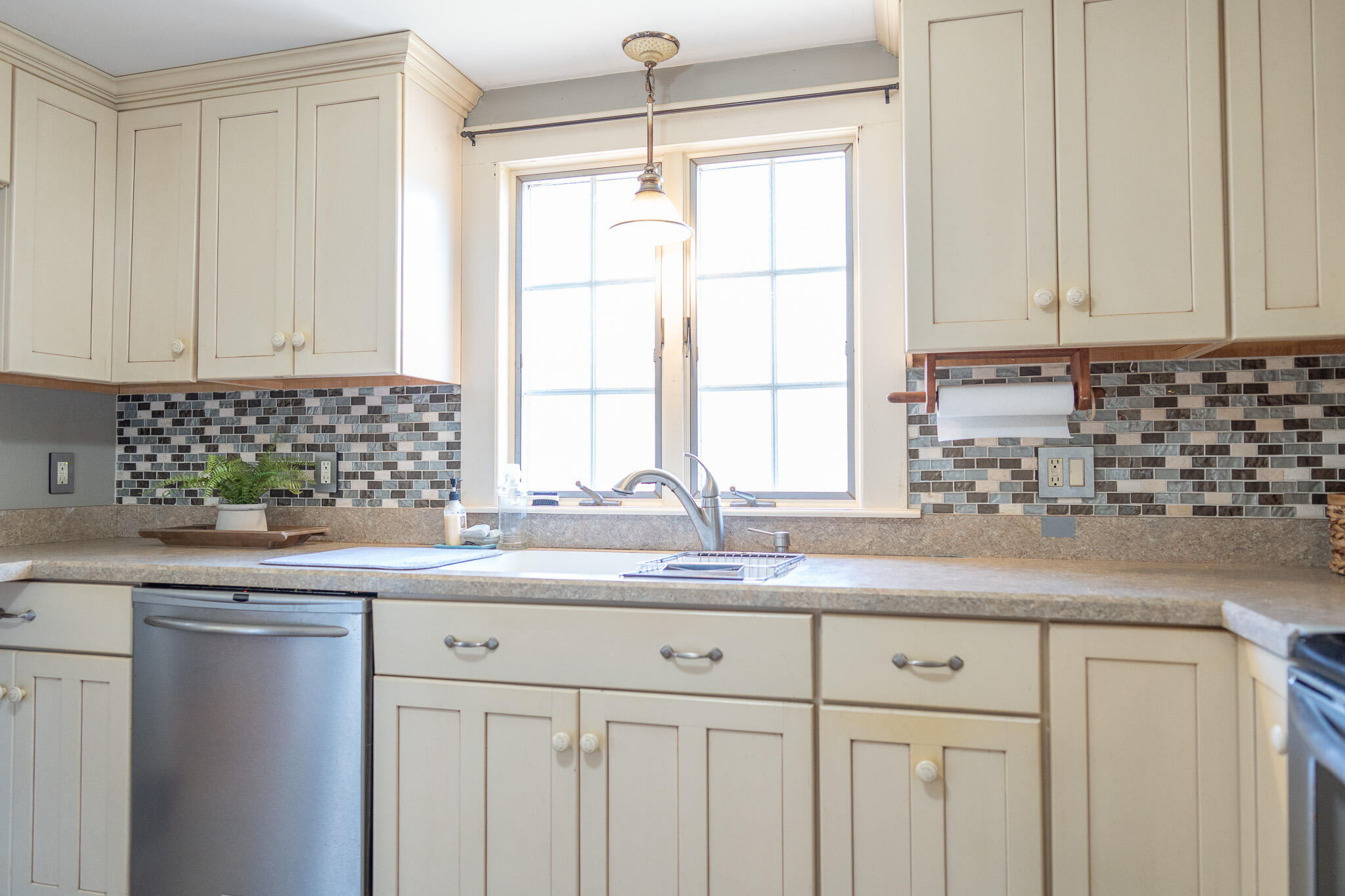49 Monument View Road East Dennis, MA 02660 - Photo 22 of 52 a kitchen with granite countertop a sink and a window