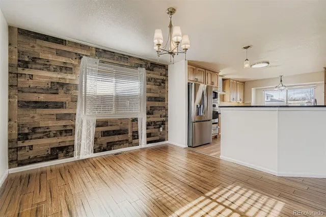 a view of a kitchen with furniture and wooden floor