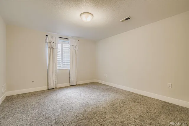 an empty room with a empty space and windows