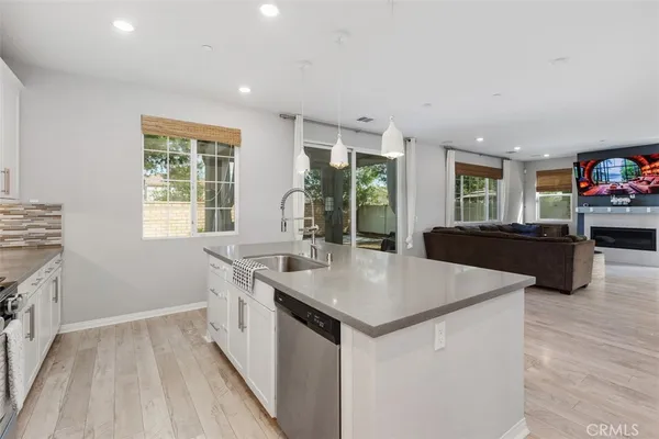 a kitchen with sink and refrigerator