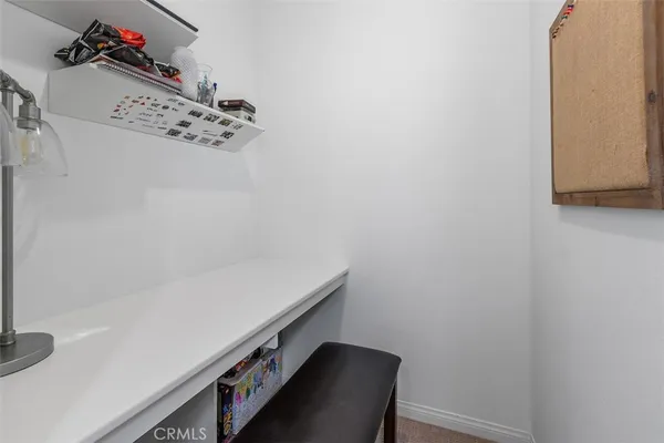 a hallway with a white cabinet