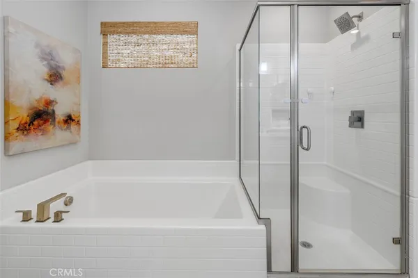 a bathroom with a bathtub and a shower