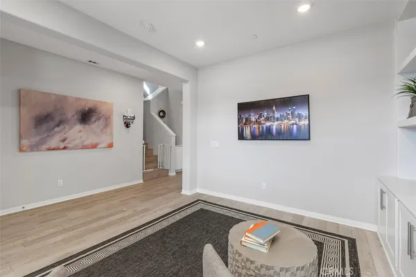 a hallway with front door and wooden floor