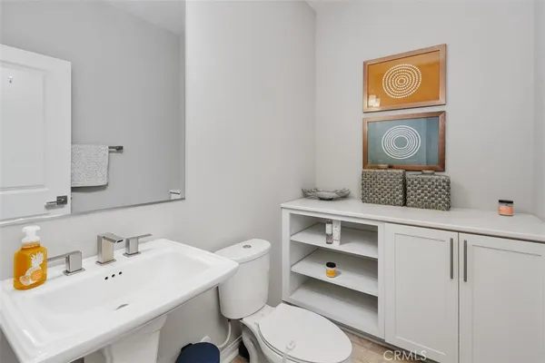a bathroom with a toilet a sink and a mirror