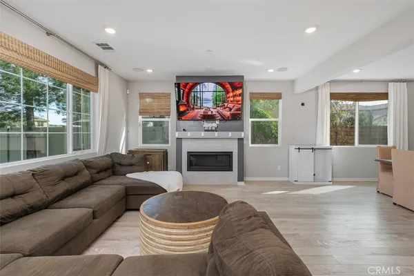 a living room with furniture a window and a fireplace