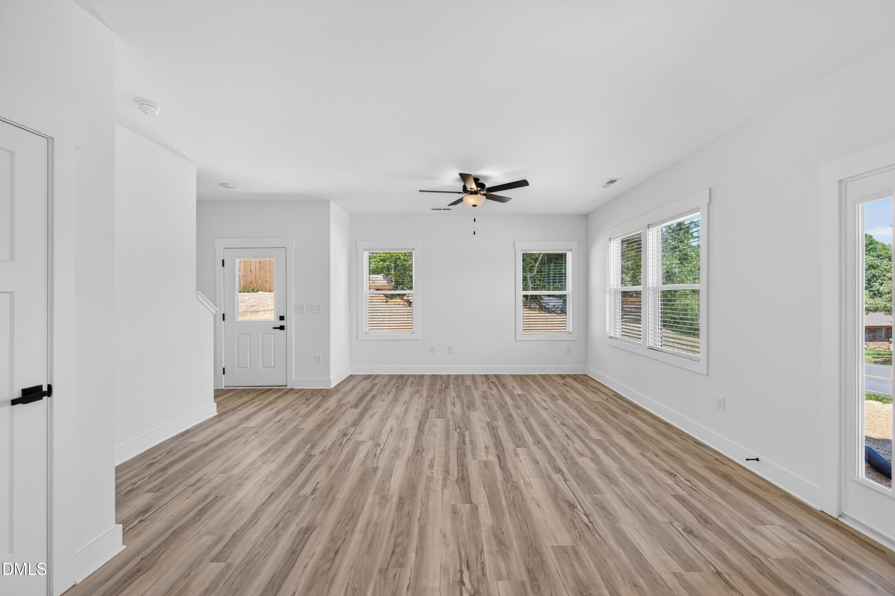 1182 Hurdle Mills Road Roxboro, NC 27573 - Photo 14 of 45 a view of an empty room with wooden floor and a window