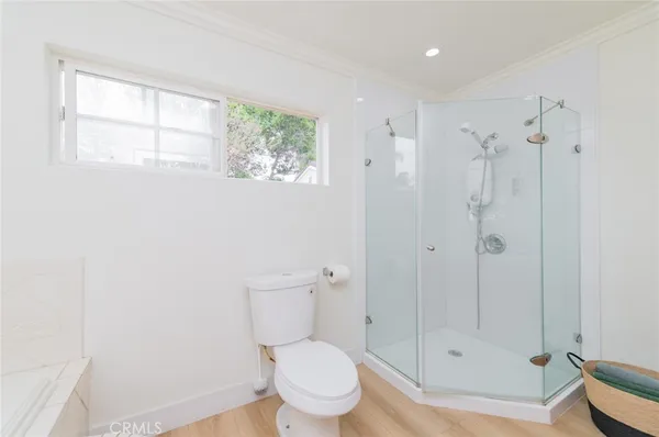 a bathroom with a toilet and a shower
