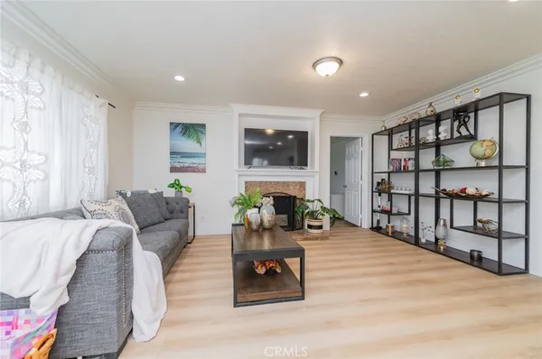 a living room with furniture a flat screen tv and a floor to ceiling window