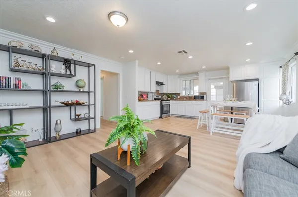 a living room with furniture and a kitchen view