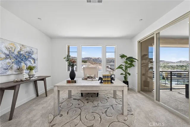 a dining room with furniture and window