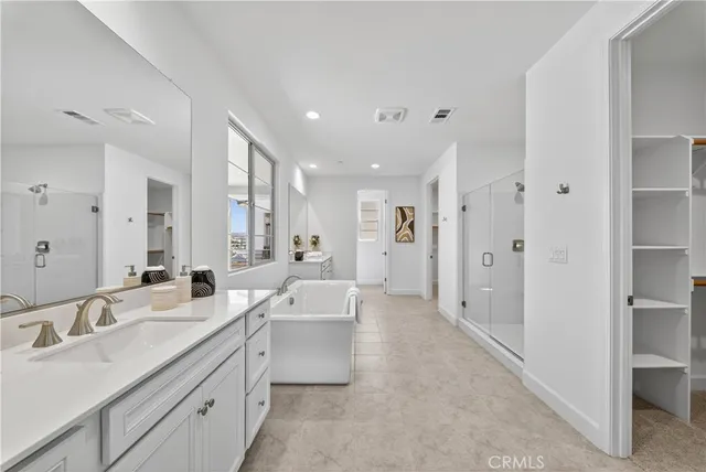 a large bathroom with a double vanity sink a mirror and a shower