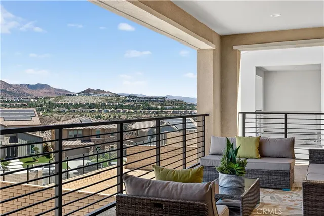 a view of a balcony with couches and wooden floor