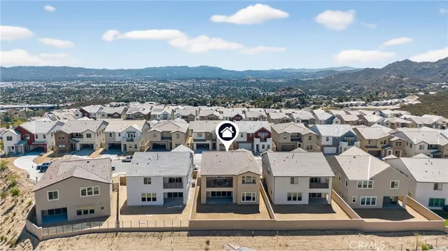 an aerial view of a house with swimming pool and seating space
