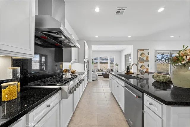 a large kitchen with lots of counter space a sink and appliances