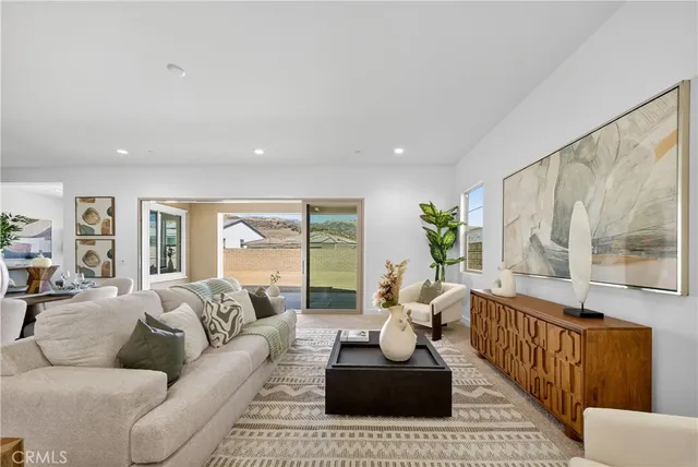 a living room with furniture and large windows