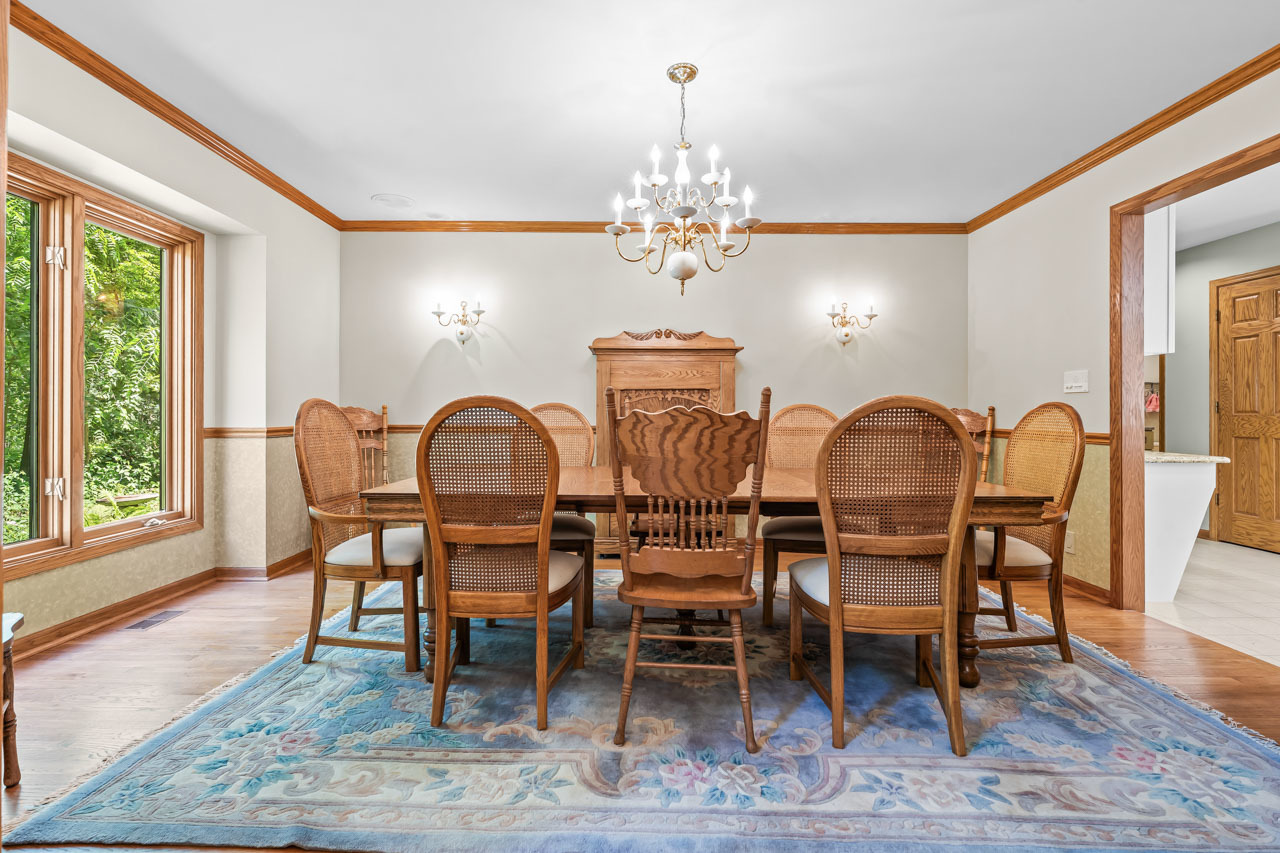 31W139 Rohrssen Road Hoffman Estates, IL 60192 - Photo 14 of 51 a view of a dining room with furniture wooden floor and chandelier