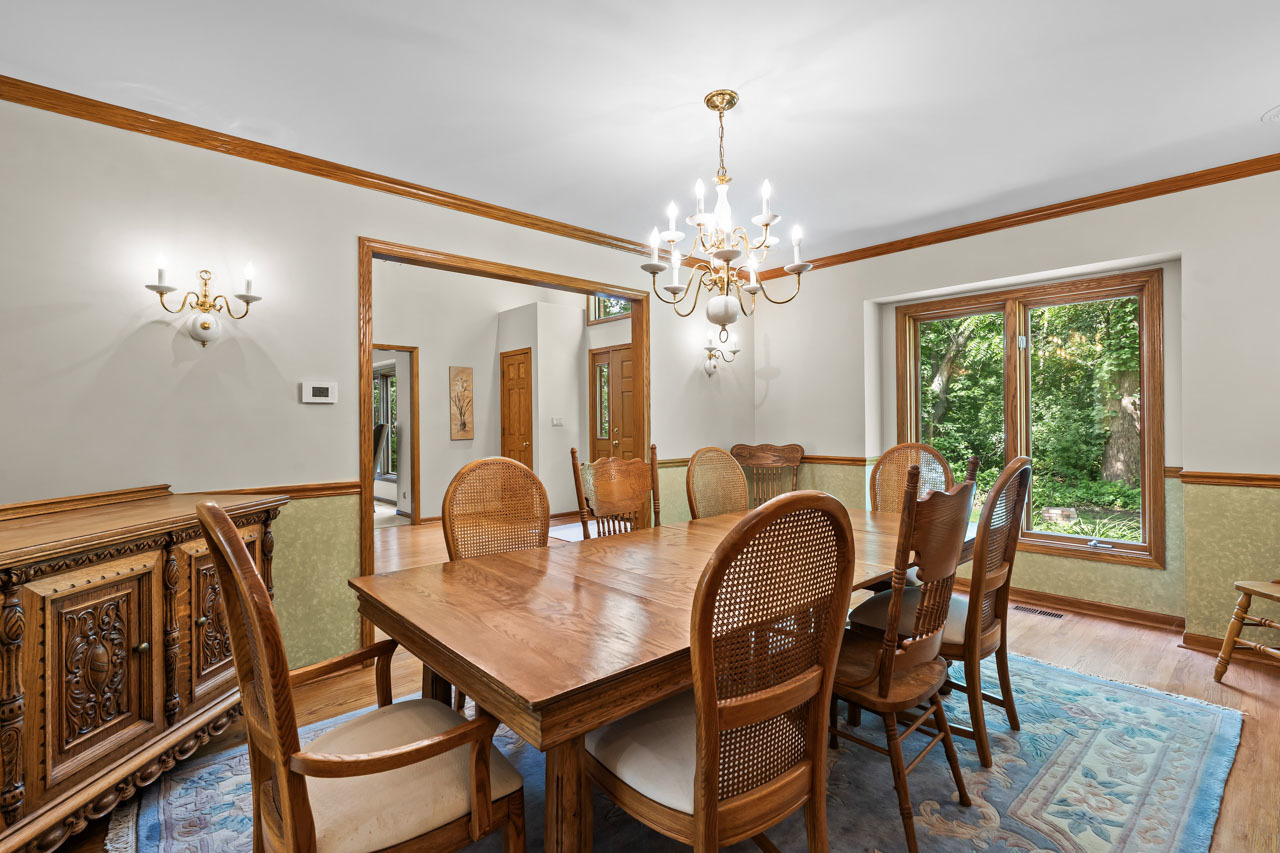 31W139 Rohrssen Road Hoffman Estates, IL 60192 - Photo 15 of 51 a dining room with furniture a chandelier and wooden floor