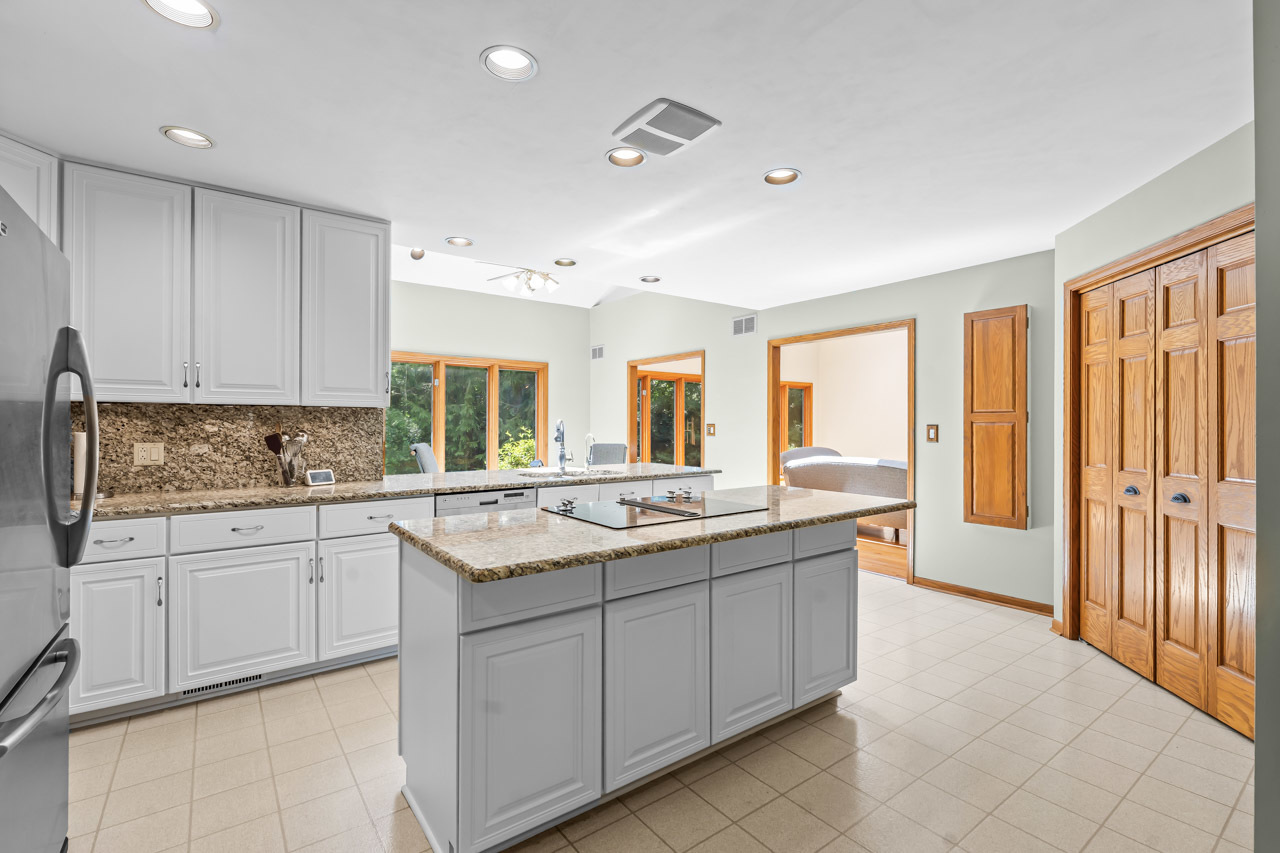 31W139 Rohrssen Road Hoffman Estates, IL 60192 - Photo 16 of 51 a kitchen with a sink stove and cabinets