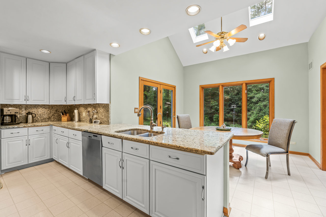 31W139 Rohrssen Road Hoffman Estates, IL 60192 - Photo 19 of 51 a open kitchen with a sink dining table and chairs