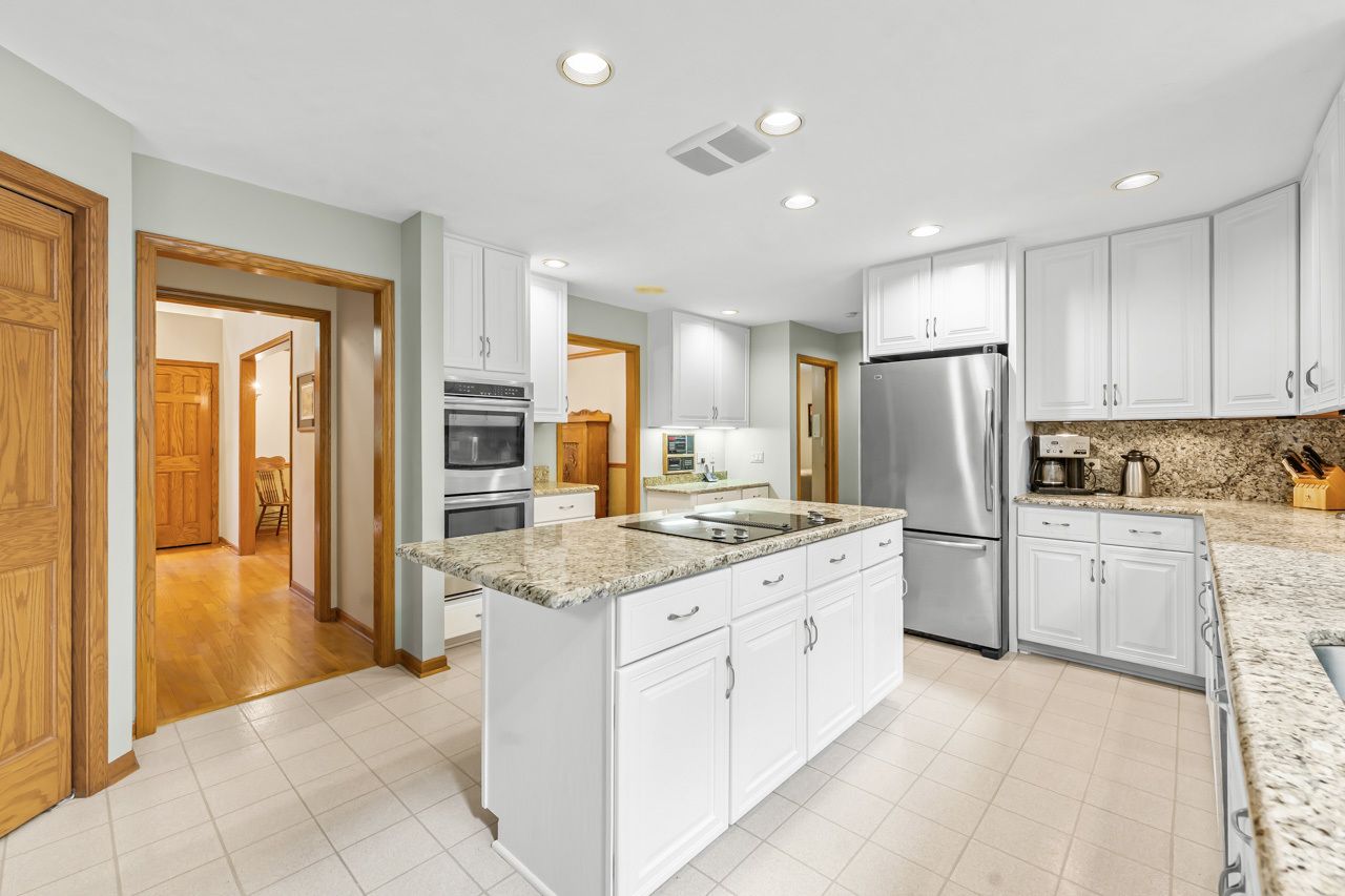 31W139 Rohrssen Road Hoffman Estates, IL 60192 - Photo 20 of 51 a large kitchen with a refrigerator a stove top oven a sink and dishwasher